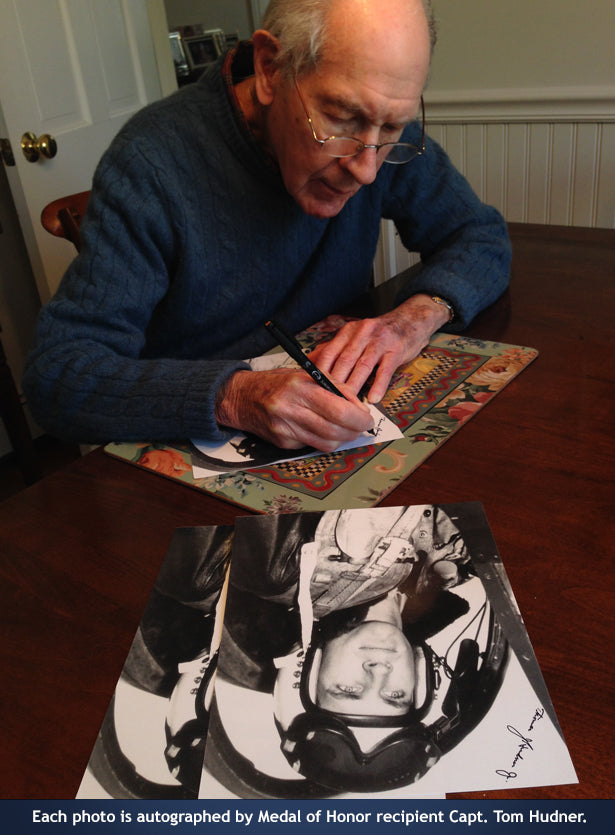 Captain Tom Hudner autographing photos